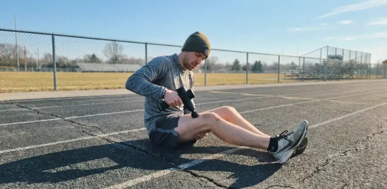 Runner experiencing gun massage benefits for leg recovery